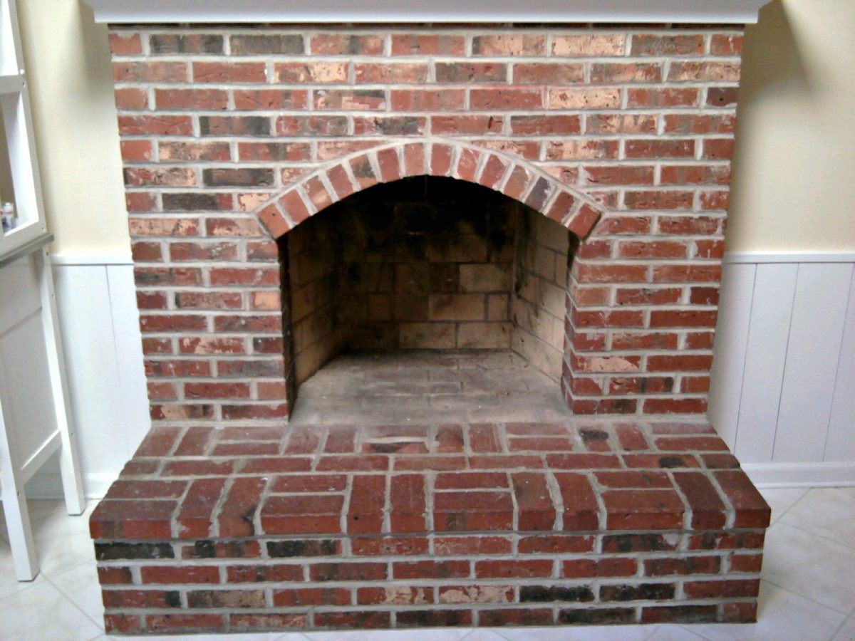 Paint the firebox or facing of your old brick fireplace