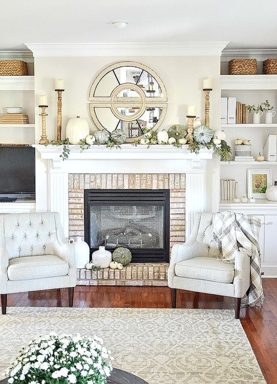 mantel with white pumpkins and greenery