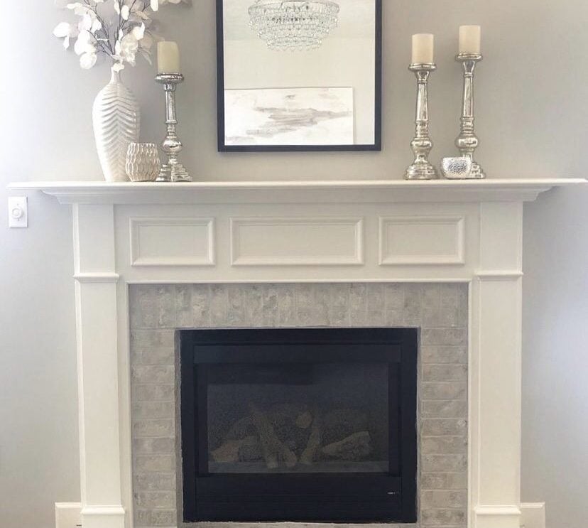 Gray painted brick fireplace with a white mantel.