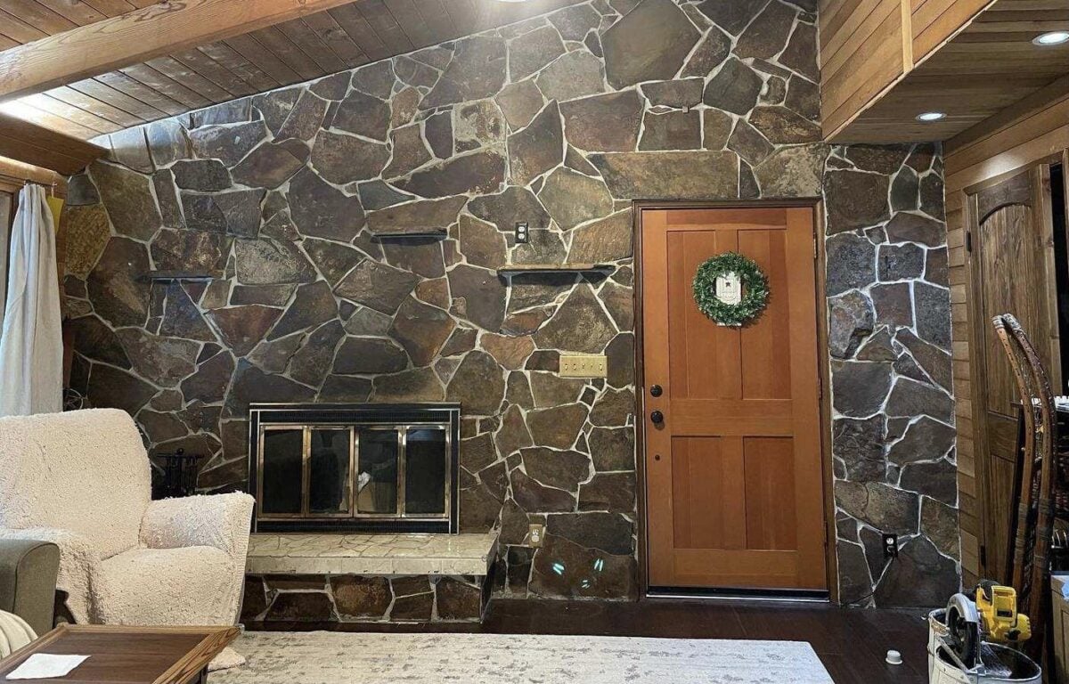 Stone fireplace that covers the whole wall, from floor to ceiling.