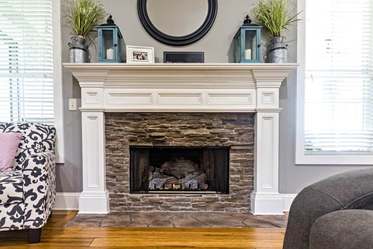 Stone fireplace with a white mantel.