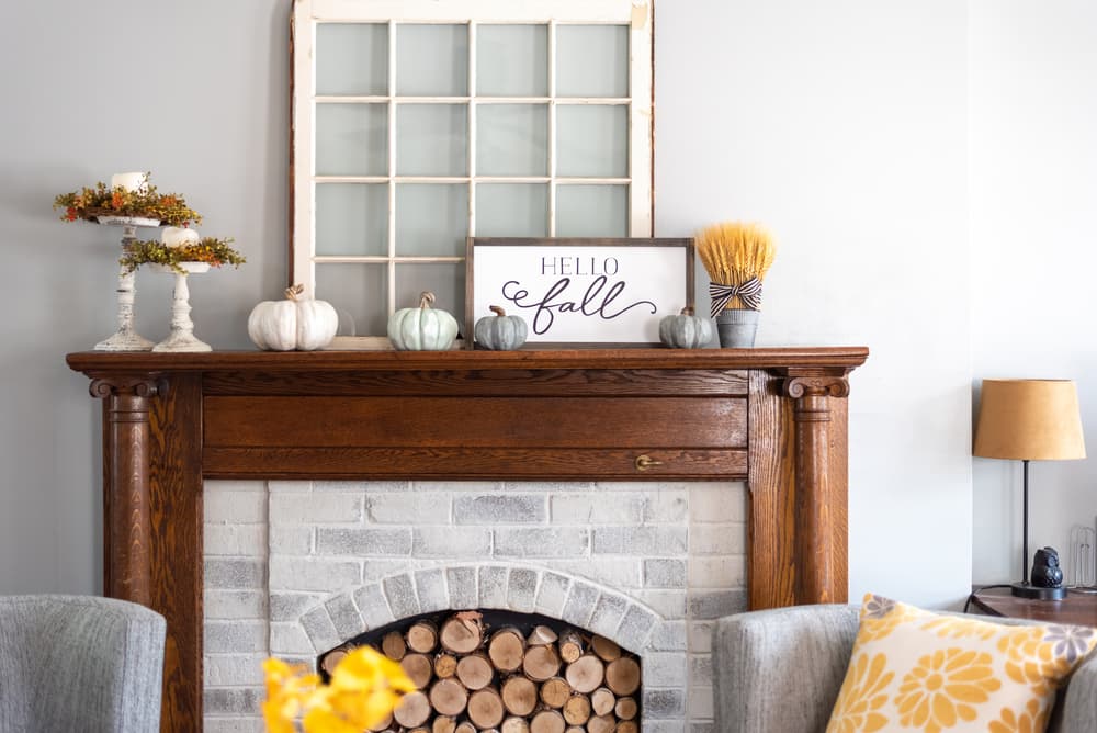 Gray painted brick fireplace matching the color of the room.
