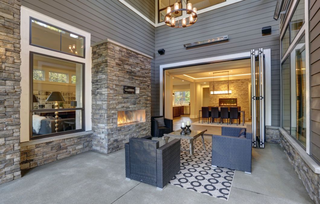 stacked stone fireplace outside the house