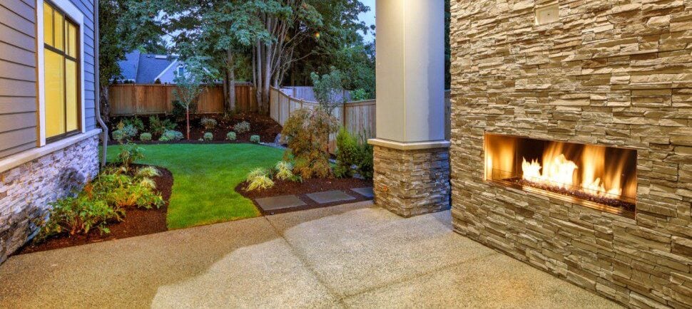 Stacked stone fireplace outside on a patio