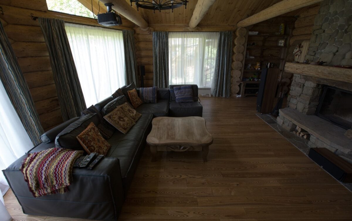 stone hearth farmhouse fireplace in a wooden cabin