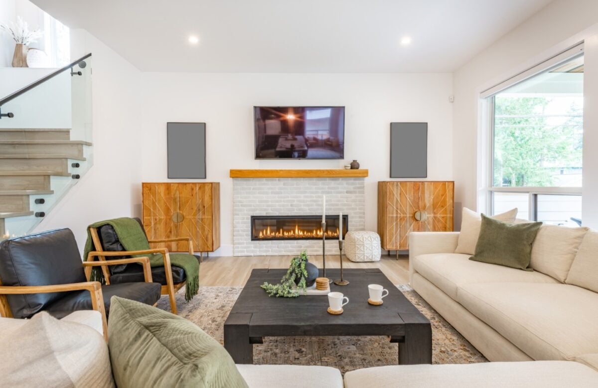 white room with a brown beam for a mantel above an electric brick fireplace