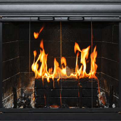 The Buckhead masonry fireplace door with a fire burning